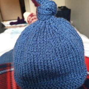 Tegan Baby Hat with Top Knot Knitting pattern by Julie Taylor